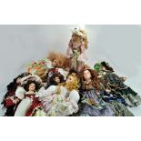 An impressive collection of larger ceramic / porcelain dolls, attractively presented by various