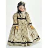 A lovely dressed German bisque and composition doll. Bisque head, grey hair, glass eyes, open