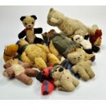 A very well loved group of bears and other stuffed animals possiby inclusive of Steiff and various