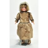 Unusual combination of a Bisque headed doll glued to a plastic soft body. Wearing a vintage handmade
