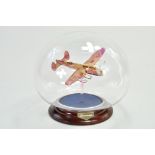 An impressive and attractive Glass Lancaster Bomber Aircraft mounted within a glass bowl with wooden