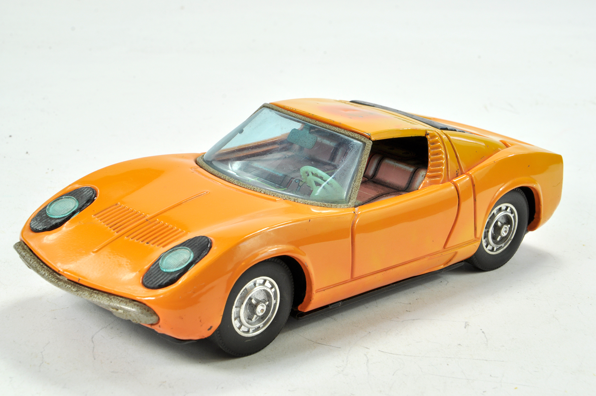 Asakusa Battery Operated Tin Plate Lamborghini Miura in orange. Good working order, some marks and