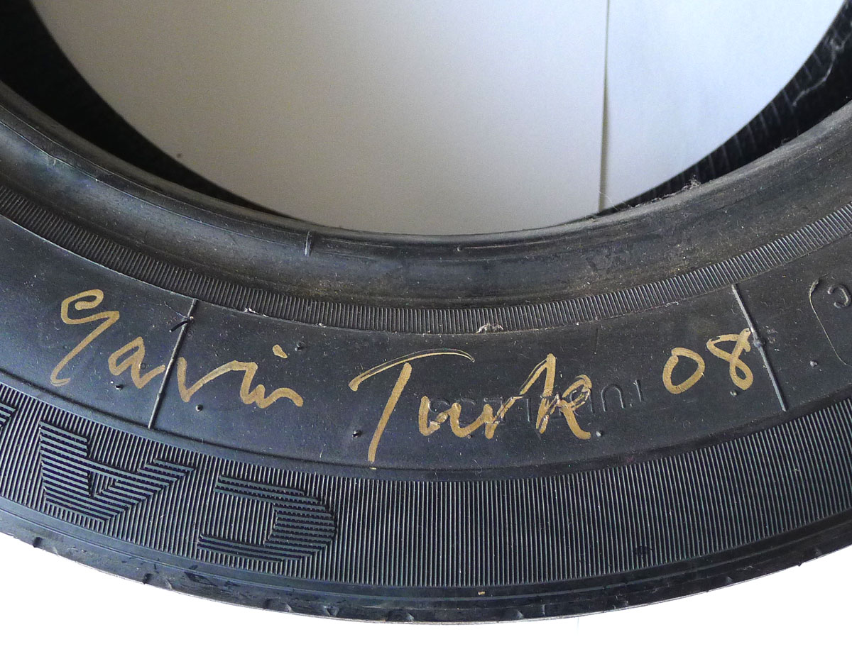 GAVIN TURK [b.1967]. Wheel Tyre, 2008. Used car tyre, signed and dated '08 in gold ink, from the - Image 2 of 2