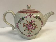 An 18th Century Pearlware squash shaped teapot with floral spray decoration and foliate moulded