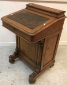 A Victorian oak Davenport, the top with stationery compartment over a writing surface,