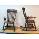 Two Windor-type slat-back rocking elbow chairs on turned supports to plain rockers,