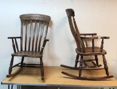 Two Windor-type slat-back rocking elbow chairs on turned supports to plain rockers,