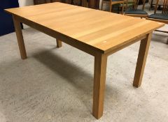 A modern light oak rectangular extending dining table on square supports (retailed be Lee Longland)