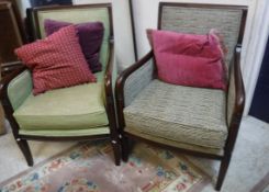 A set of three modern armchairs with stained show frames and coordinating upholstery,