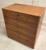 A 1960's yew wood chest of five long graduated drawers with brass flush handles,