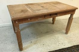 A modern pine dining table and six pine panel seated chairs,