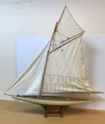 A modern scale model of a single masted sea going yacht on a purpose built wooden stand, 114.