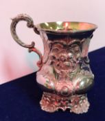 A Victorian silver and embossed christening mug with open cartouche and gilt-washed interior raised