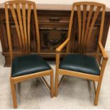 A set of eight Robin Furlong oak dining chairs with leather upholstered seats, stamped,