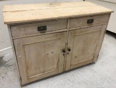 A circa 1900 Polish limed pine larder cupboard with two drawers over two cupboard doors with tin