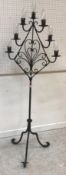 A modern wrought iron seven light lamp standard on scroll work tripod base,