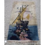 An Art Deco Chinese rug with ship design in yellow and blue colour way,