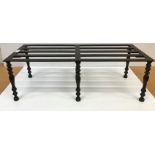 A 19th Century cast iron trivet, the slatted two part top on six baluster turned and ringed legs,