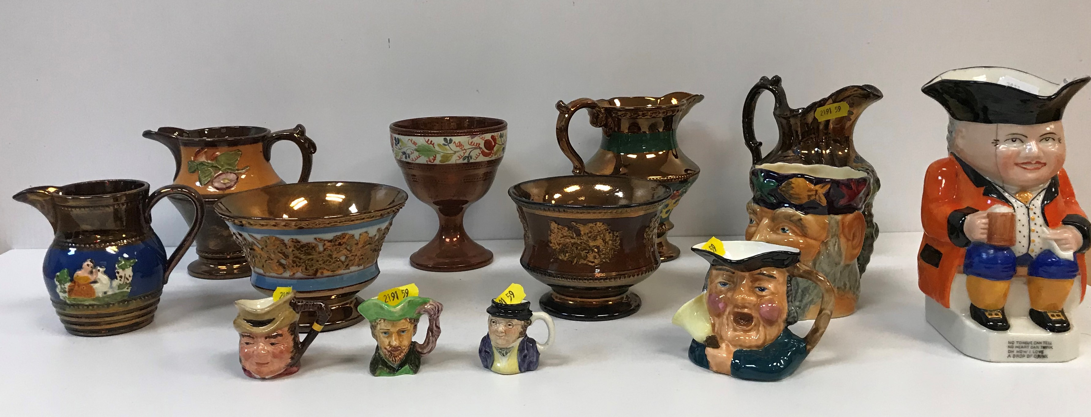 A collection of four Victorian copper lustre cream jugs, copper lustre goblet and two bowls,