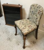 An early 20th Century upholstered walnut-framed hall chair, the low back with fingerhold verso,