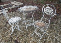 A modern cream metal painted bistro set of table and two chairs