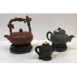 A Chinese Yi Xing teapot with figural decorated handle and script decorated main body,