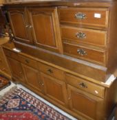 A modern mahogany Stag sideboard, the plain top above four drawers and four cupboards,