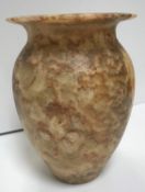 An Egyptian hand-carved alabaster vase of urn form with flared rim, of mottled cream,