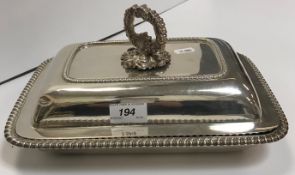 A George III silver vegetable tureen of rectangular form with gadrooned edge,