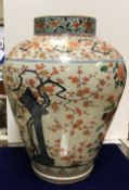 A 19th Century Chinese Imari urn shaped vase and cover decorated with sprays of flowers and prunus