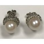 A pair of 9 carat white gold mounted diamond and pearl ear studs, pearl size approx 14, (approx 0.