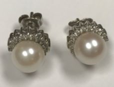 A pair of 9 carat white gold mounted diamond and pearl ear studs, pearl size approx 14, (approx 0.