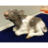 A collection of five various Royal Copenhagen animal figures including a recumbant calf (no.