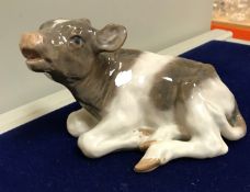 A collection of five various Royal Copenhagen animal figures including a recumbant calf (no.