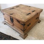 A modern pine box coffee table with two rising lids and wrought iron hinges and handles,