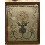 An 18th Century silk and gold wire needlework panel as a stylised cornucopia of flowers within a