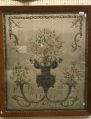 An 18th Century silk and gold wire needlework panel as a stylised cornucopia of flowers within a