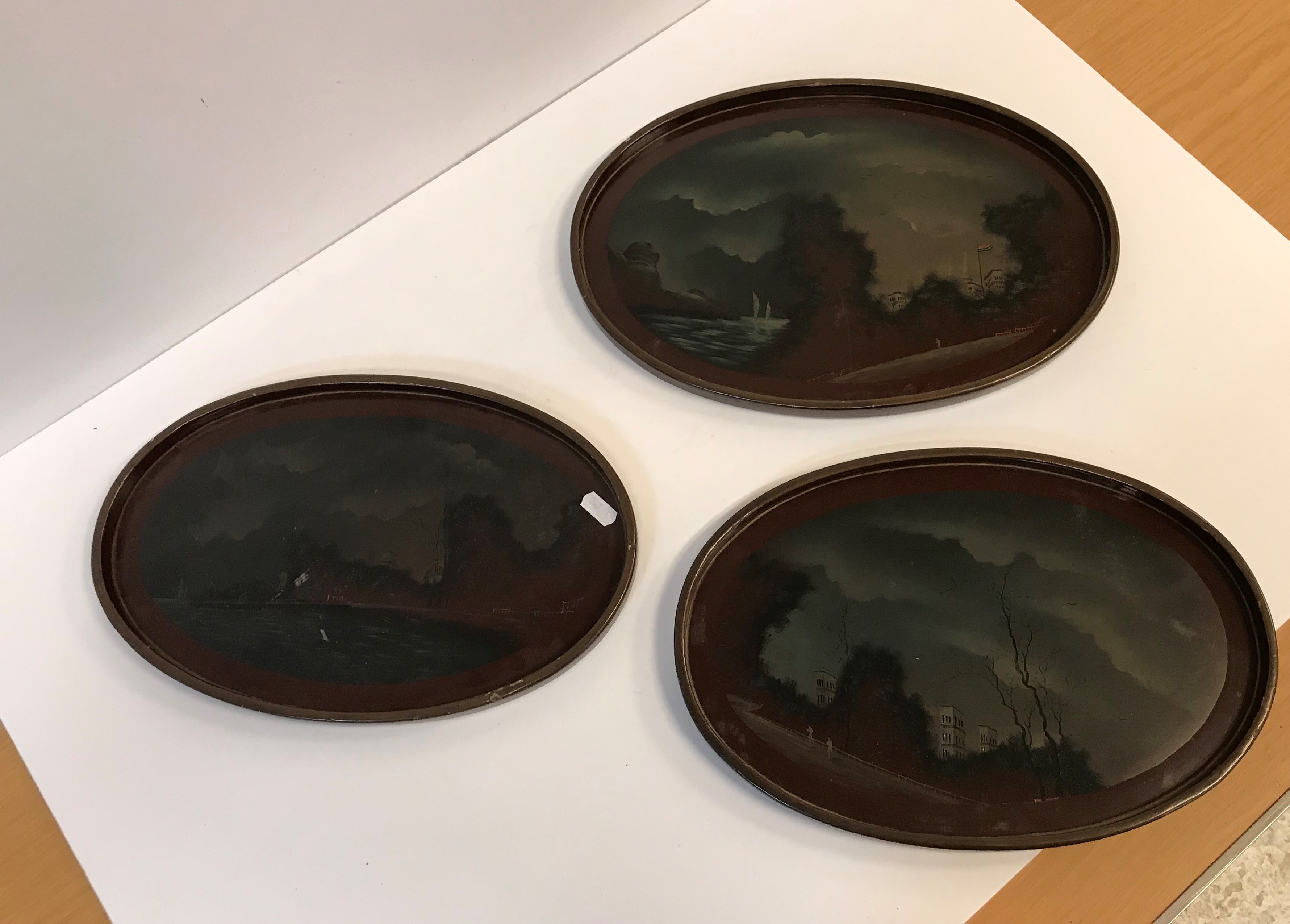 A graduated set of three circa 1900 Japanese lacquered trays, each decorated with landscape scenes,