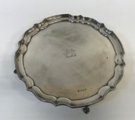 An Elizabeth II silver salver in the Georgian style with central lozenge lion motif,