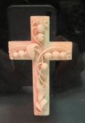 A late Victorian carved ivory cross decorated in high relief with lily of the valley,