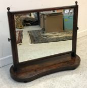 A 19th Century mahogany dressing mirror with rectangular swing plate on shaped base,