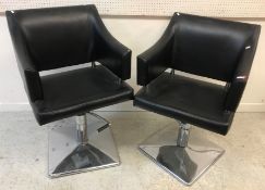 A pair of modern adjustable black and chrome bar chairs,