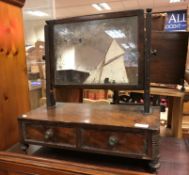 A circa 1830 mahogany toilet mirror, the rectangular plate on reeded supports to a two-drawer base,