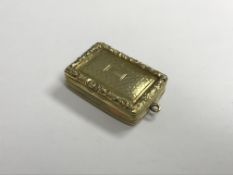 An early Victorian silver gilt vinaigrette with engine-turned and relief work scrolling foliate