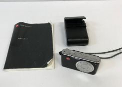 A Leica C-Lux I camera with leather case and instruction manual