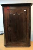 A 19th Century oak hanging corner cupboard,