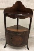 A 19th Century mahogany corner washstand with galleried back over three bowl recesses and cover,