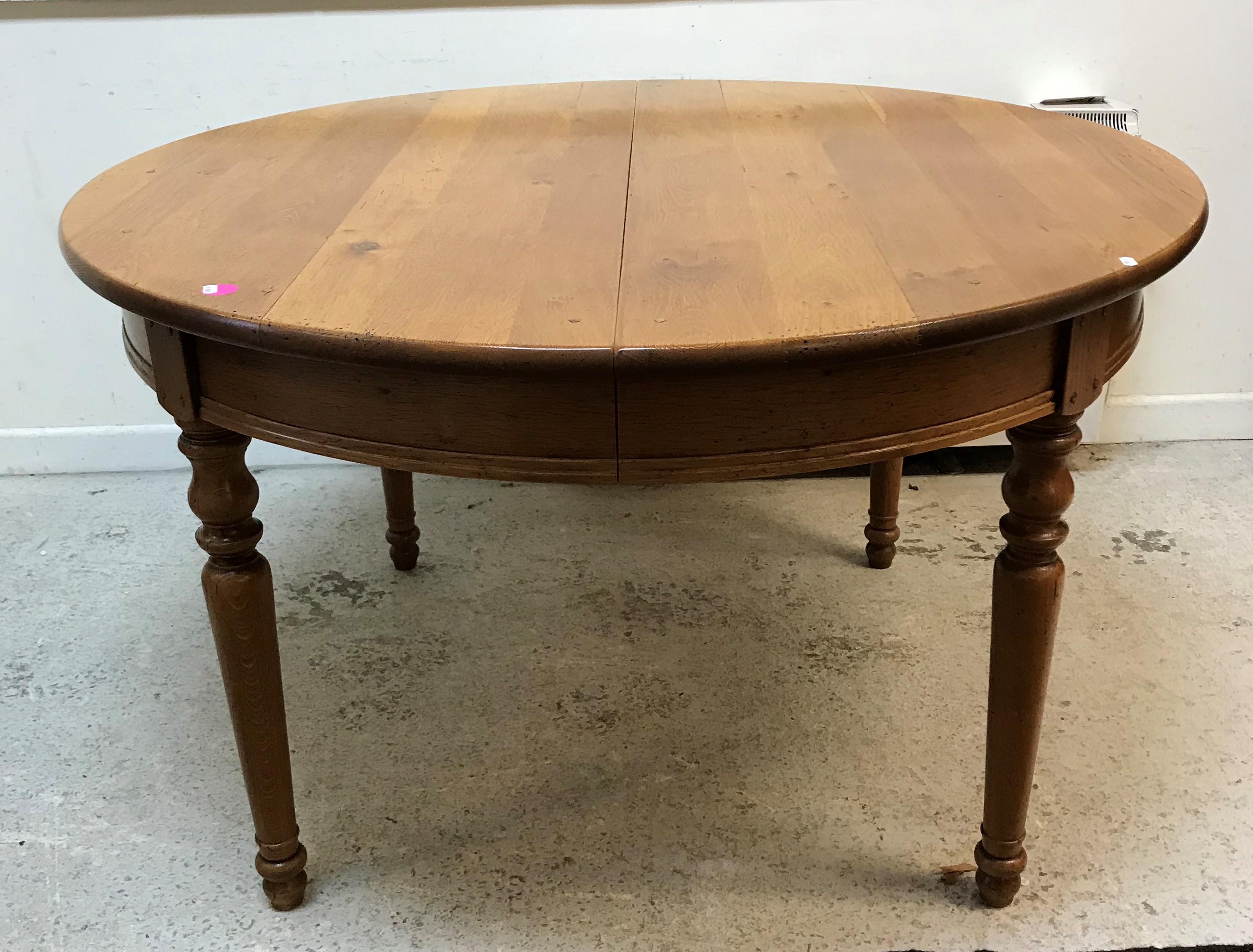 A modern oak circular dining table in the Victorian manner,