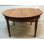 A modern oak circular dining table in the Victorian manner,