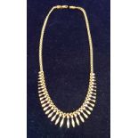 A 9 carat gold necklace of graduated lozenge and cut lozenge design, 43 cm long overall,